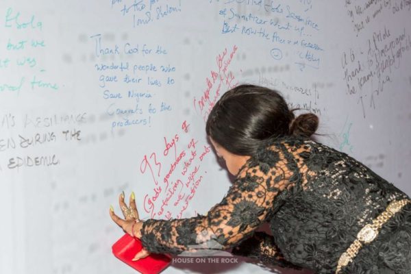 Kenny Saint Brown signing the wall