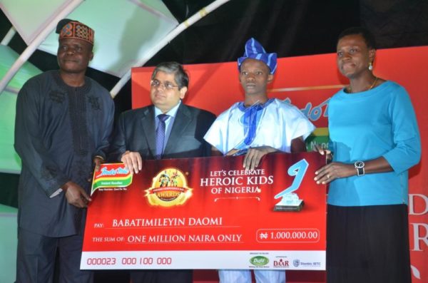 l-r: director of marketing, daar communications plc, mr lanre awoyemi; group managing director, dufil prima foods plc, mr deepak singhal; winner, intellectual bravery category, 2016 indomie independence day awards for heroes of nigeria (iida), master babatimileyin daomi, and managing director, stanbic holdings plc, mrs shola david-borha, at the 2016 iida held in lagos