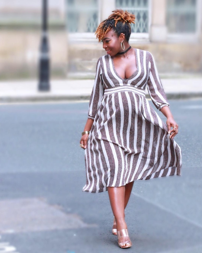 Lydia Epangue balances extra exposure with sleeves and a midi length, flared dress.