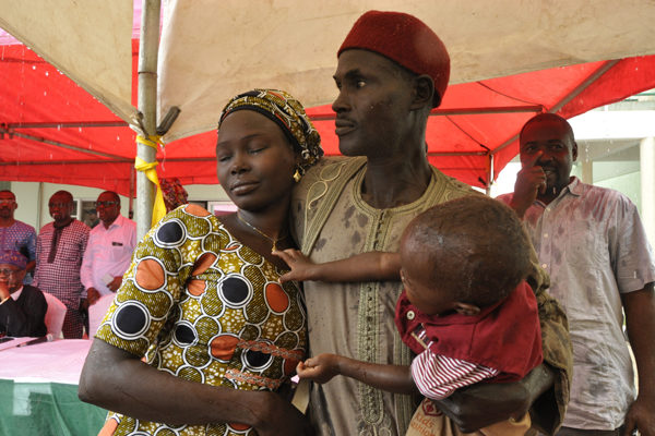 Deborah Jafaru with her father and her baby