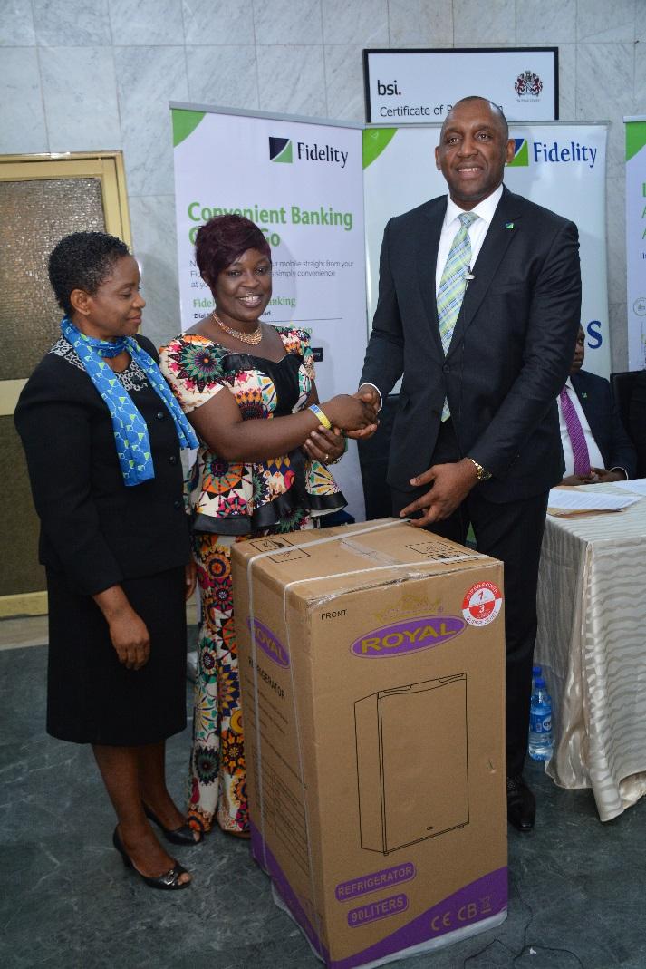 L-R, Janet Nnabuko, Group Head, Savings; Chibuzor Ariguzo, Winner of Refrigerator set and Obaro Odeghe, Promo Committee Chairman, Fidelity Bank during the prize presentation ceremony in Lagos