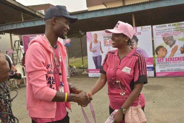 Runcie C.W. Chidebe, Executive Director of Project PINK BLUE presenting Goodwill Ambassador for Breast Cancer Medal to Annie Idibia at Pink October Walk against Cancer for her advocacy and support to women battlin