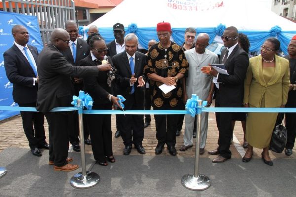 Okamaka Okoye, Managing Director, Juhel Nigeria Ltd. and customer, Union Bank cutting the ribbon to launch the Union Bank, Zik Avenue branch in Enugu