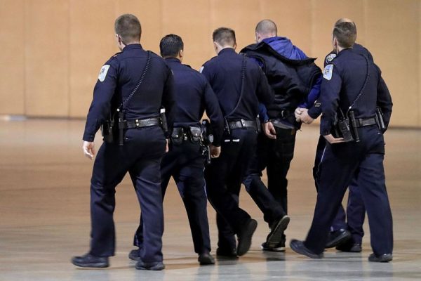 RENO, NV - NOVEMBER 05:  Police officers and U.S. Secret Service take a man away in handcuffs from a campaign rally for Republican presidential nominee Donald Trump at the Reno-Sparks Convention Center November 5, 2016 in Reno, Nevada. With less than a week before Election Day in the United States, Trump and his opponent, Democratic presidential nominee Hillary Clinton, are campaigning in key battleground states that each must win to take the White House.  (Photo by Chip Somodevilla/Getty Images)