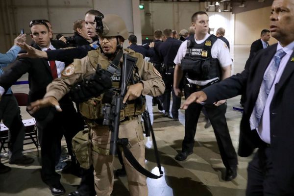 RENO, NV - NOVEMBER 05:  Police officers and U.S. Secret Service rush a man in handcuffs out of a campaign rally for Republican presidential nominee Donald Trump at the Reno-Sparks Convention Center November 5, 2016 in Reno, Nevada. With less than a week before Election Day in the United States, Trump and his opponent, Democratic presidential nominee Hillary Clinton, are campaigning in key battleground states that each must win to take the White House.  (Photo by Chip Somodevilla/Getty Images)