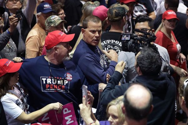 RENO, NV - NOVEMBER 05:  CNN's Noah Gray (R) is shoved and shouted at by supporters of Republican presidential nominee Donald Trump as he trys to cover breaking news during a campaign rally the Reno-Sparks Convention Center November 5, 2016 in Reno, Nevada. With less than a week before Election Day in the United States, Trump and his opponent, Democratic presidential nominee Hillary Clinton, are campaigning in key battleground states that each must win to take the White House.  (Photo by Chip Somodevilla/Getty Images)