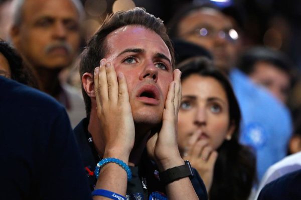 NEW YORK, NY - NOVEMBER 08:  A man reacts as he watches voting results at Democratic presidential nominee former Secretary of State Hillary Clinton's election night event at the Jacob K. Javits Convention Center November 8, 2016 in New York City. Clinton is running against Republican nominee, Donald J. Trump to be the 45th President of the United States.  (Photo by Aaron P. Bernstein/Getty Images)