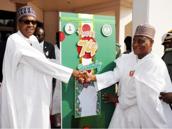 President Muhammadu Buhari (L) receiving a Birthady Card from the Minister of Defence, Brig.Gen. Mansur Dan- Ali during a special 74th Birthday Parade for President Muhammadu Buhari at the Presidential Villa Abuja on Saturday (17/12/16/) 9155/17/12/2016/CALLISTUS EWELIKE/NAN