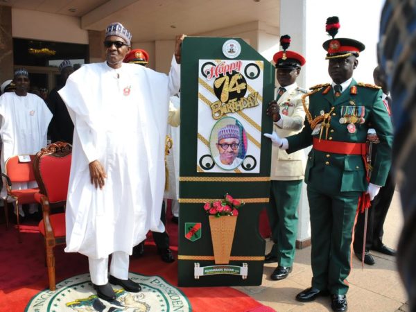  President Muhammadu Buhari (L) receiving a Birthady Card from Commander, Guards Brigade, Mohammed Yusuf during a special 74th Birthday Parade for President Muhammadu Buhari at the Presidential Villa Abuja on Saturday (17/12/16/) 9156/17/12/2016/CALLISTUS EWELIKE/NAN