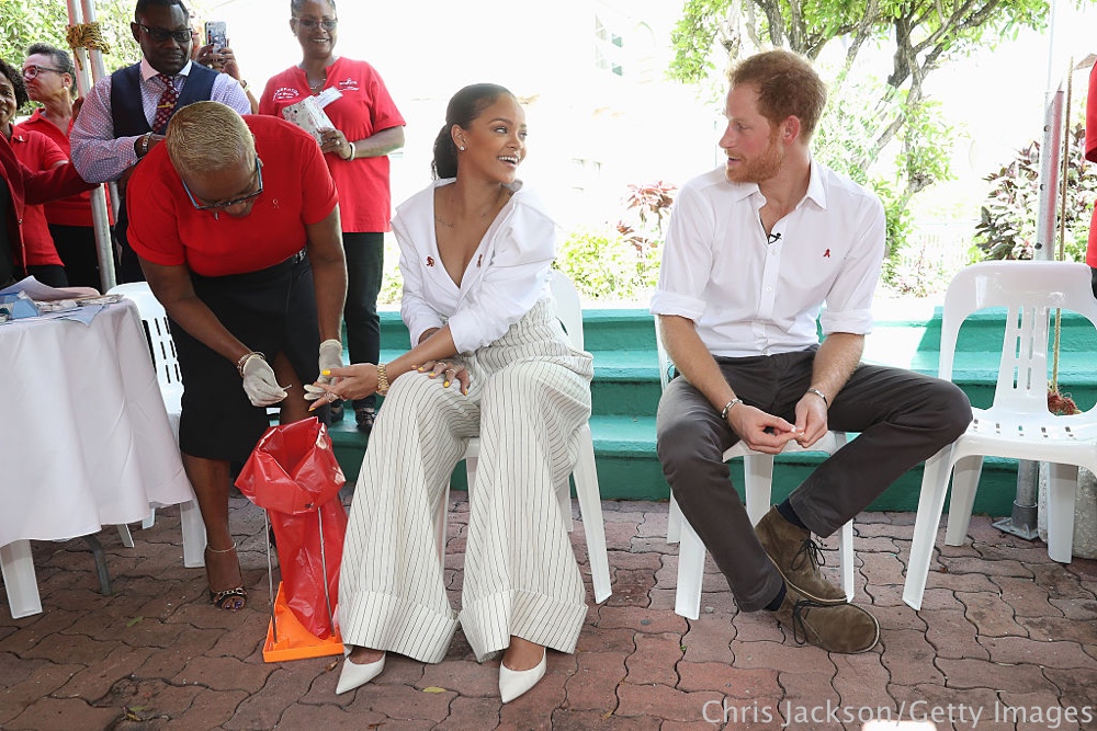 BRIDGETOWN, BARBADOS - DECEMBER 01: Prince Harry (R) watches as Singer Rihanna (L) gets her blood sample taken for an live HIV test, in order to promote more widespread testing for the public at the 'Man Aware' event held by the Barbados National HIV/AIDS Commission on the eleventh day of an official visit on December 1, 2016 in Bridgetown, Barbados. Prince Harry's visit to The Caribbean marks the 35th Anniversary of Independence in Antigua and Barbuda and the 50th Anniversary of Independence in Barbados and Guyana. (Photo by Chris Jackson - Pool/Getty Images)