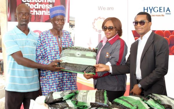 Hygeia HMO and Ikeja Electric presenting treated Mosquito nets to Community head of Ilaje community of Bariga on World Malaria Day R-L Ekeno Eyo (Hygeia), Ibiene Okeleke (Ikeja Electric), Community head of Ilaje community, Bariga