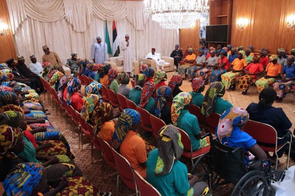 President Buhari receiving the released girls on Sunday