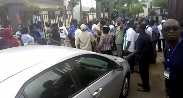 Police teargas protesting staff as they escort NHIS Boss into Premises | BellaNaija