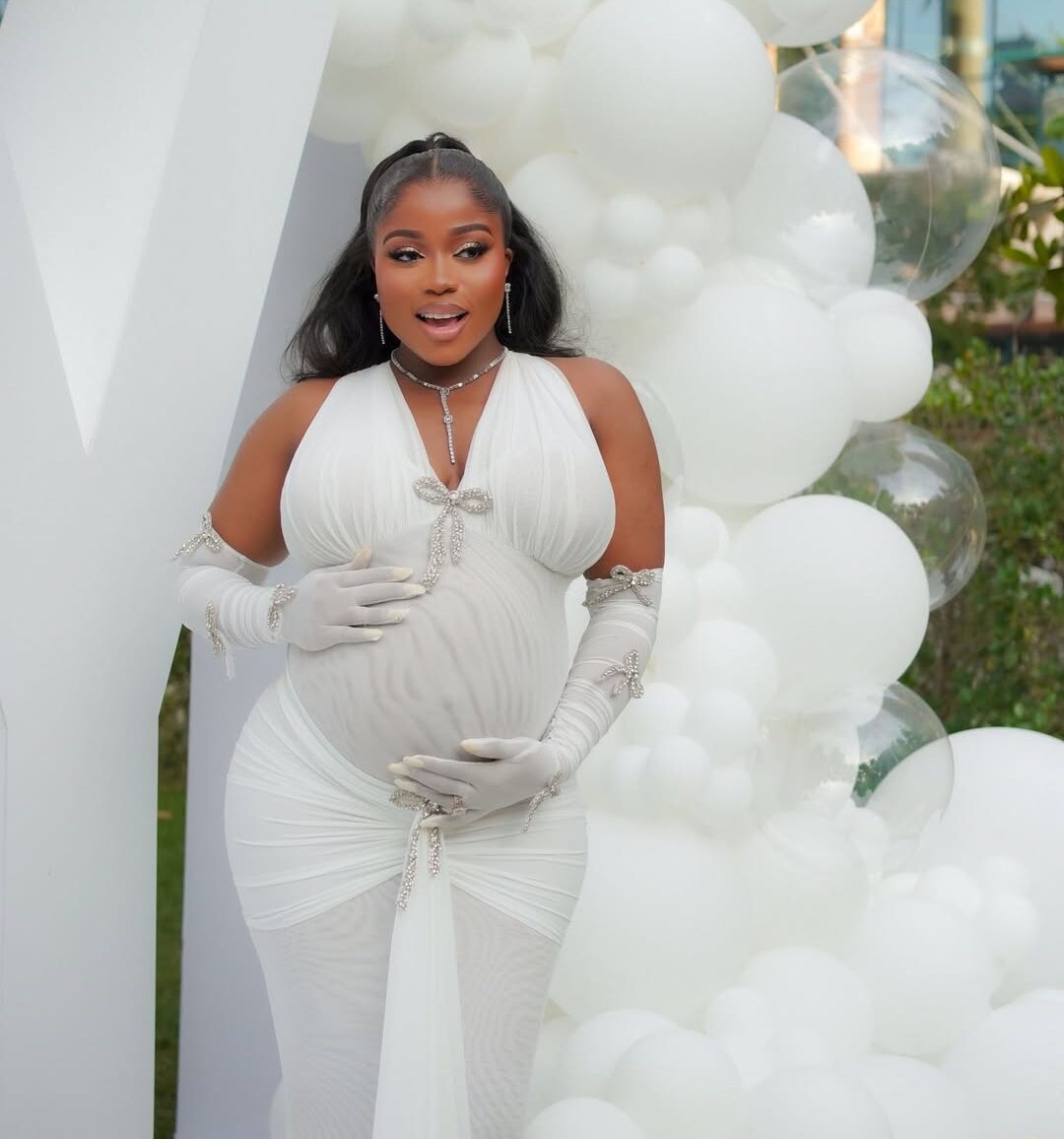 Veekee James’s White Maternity Gown Featured Opera Gloves and Crystal Details