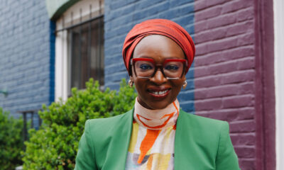 A professional portrait of Nabila Aguele, the first Nigeria-based Global CEO of Malala Fund, wearing a green blazer and red headwrap.
