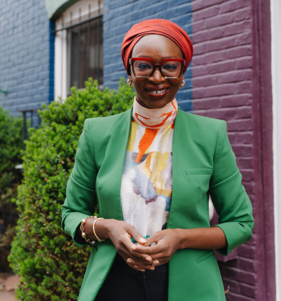 A professional portrait of Nabila Aguele, the first Nigeria-based Global CEO of Malala Fund, wearing a green blazer and red headwrap.