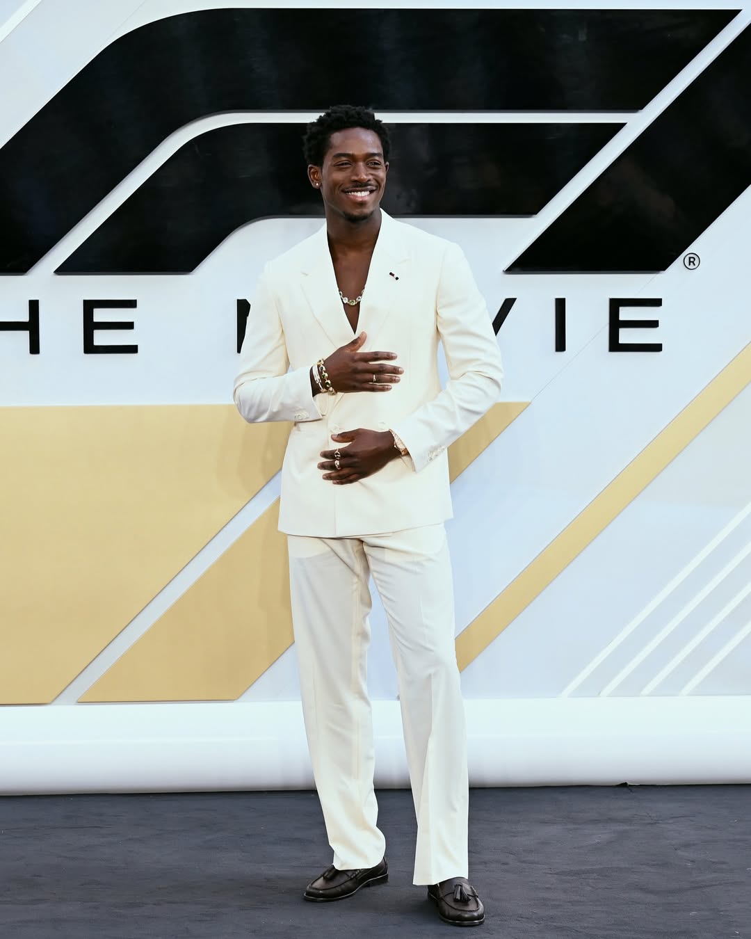 British-Nigerian actor Damson Idris in a white double-breasted suit at the F1 movie premiere in London, June 2025.