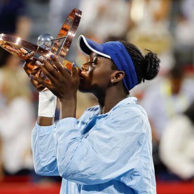 Victoria Mboko holding the National Bank Open trophy at IGA Stadium in Montreal after defeating Naomi Osaka in the 2025 final.