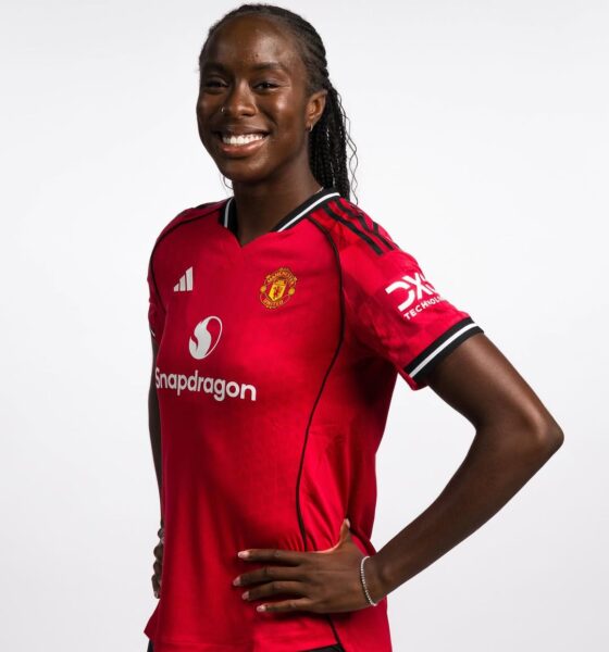 Official studio portrait of Simi Awujo, Manchester United Women’s midfielder. She is smiling, with her hair in neat braids, wearing the 2025/26 red home kit featuring the Snapdragon sponsor logo.