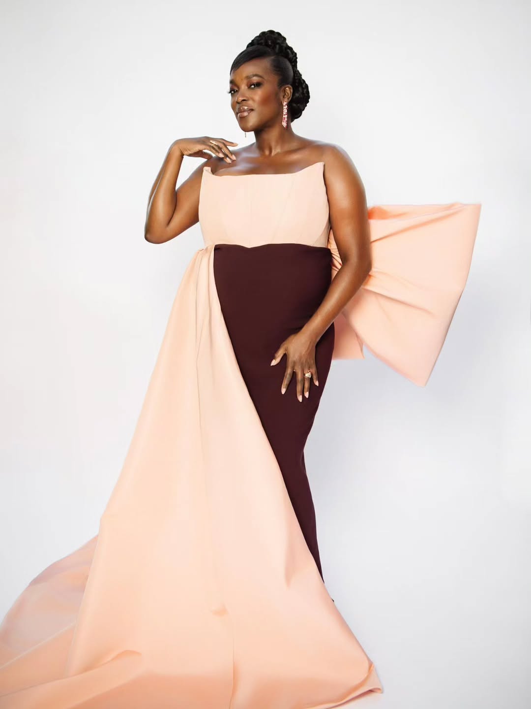 British-Nigerian actress Wunmi Mosaku wearing a custom blush and burgundy gown to accept her Best Supporting Actress award for Sinners at the 2026 NAACP Image Awards at the Pasadena Civic Auditorium in Los Angeles, California.