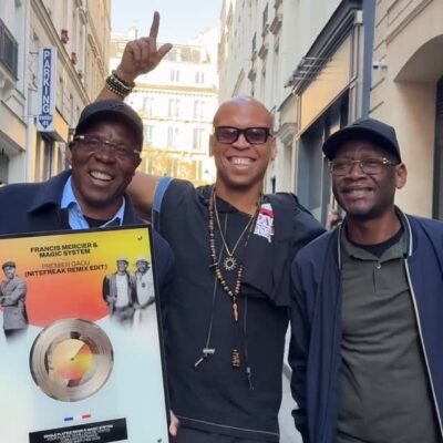 Haitian DJ Francis Mercier and Ivorian group Magic System celebrating their Platinum plaque for the Premier Gaou Nitefreak Remix in Paris.