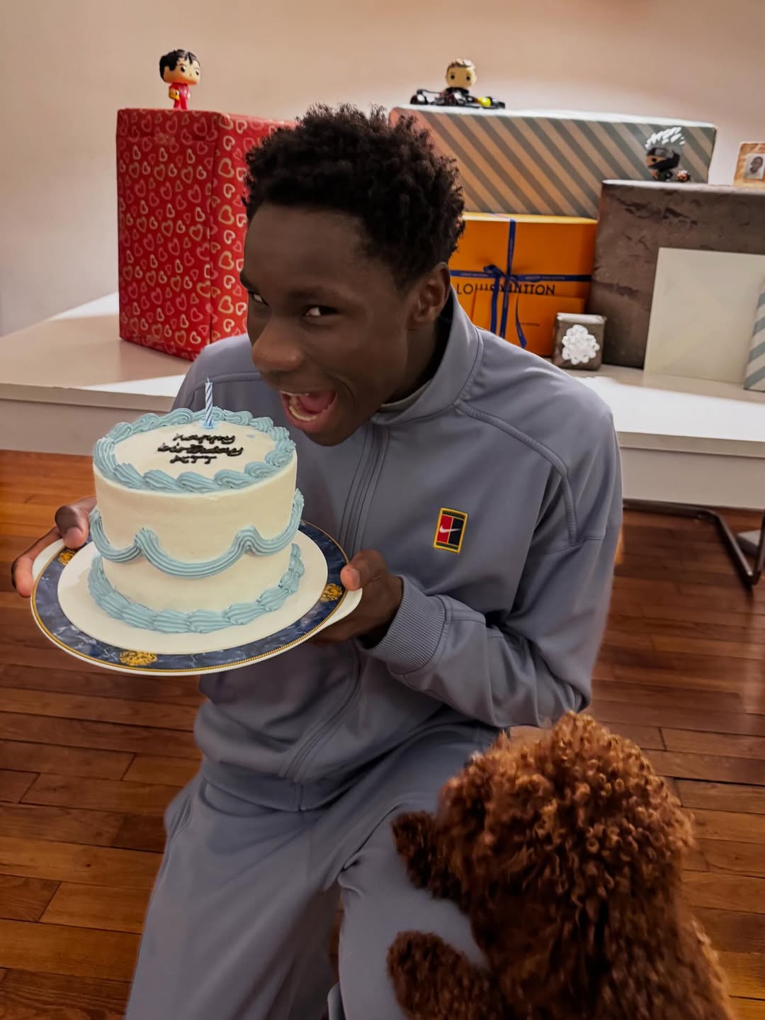 Tennis prodigy Moïse Kouame holding a blue and white birthday cake in March 2026, just eight days before his breakthrough win in Miami.