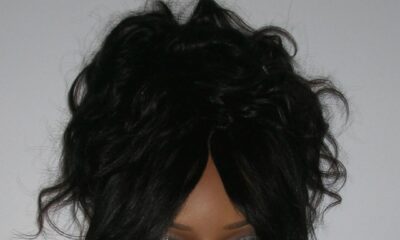 ayra Starr in a leopard print vest with a monochromatic purple beauty look, featuring lilac eye shadow and matching lilac nails.