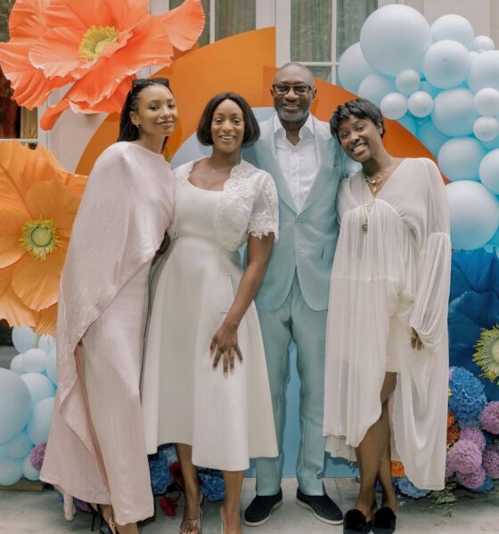 Femi Otedola with his daughters Cuppy, Temi Ajibade, and Tolani Otedola in coordinated white and cream outfits for International Women's Day 2026.