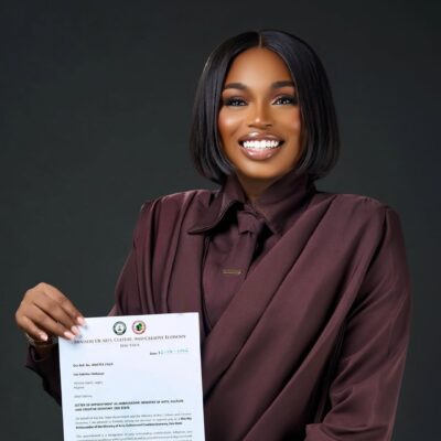Sabrina Idukpaye holding her official letter from the Edo State Ministry of Arts and Culture.
