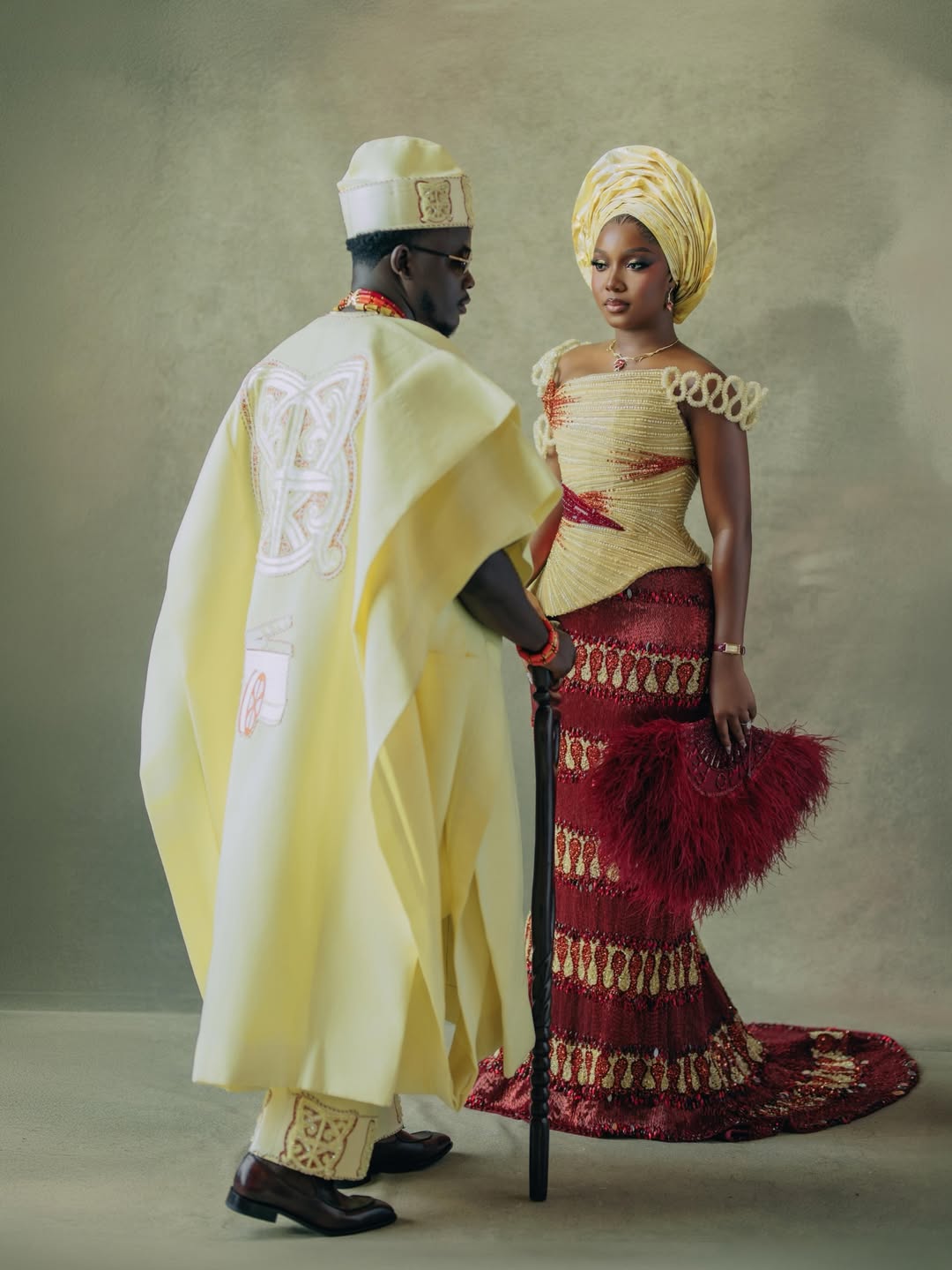 Simi Sanya in a beaded burgundy and champagne gown by Veekee James and Femi Dapson in a champagne agbada by Tochini Bespoke for their second look.