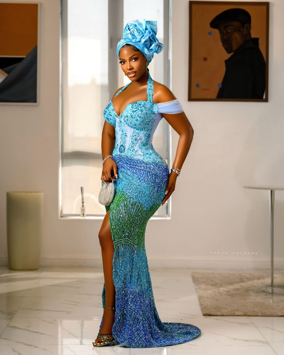 Hilda Baci wearing a custom sky blue to emerald green ombre beaded mermaid gown and turquoise gele.