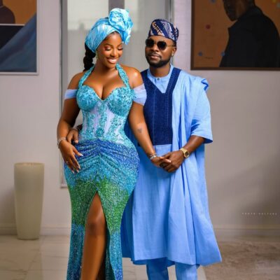 Hilda Baci and Damilola Akinwunmi posing together in coordinated blue traditional outfits at the Simi Sanya and Femi Dapson's traditional wedding.