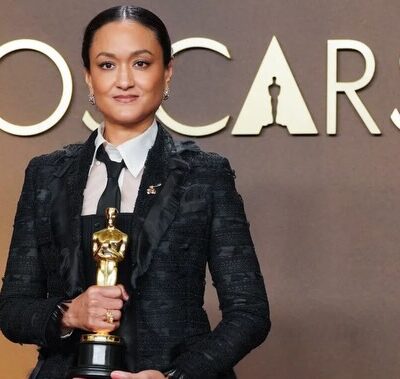Cinematographer Autumn Durald Arkapaw holding her Academy Award for Best Cinematography for the film Sinners, wearing a black structured coat and tie at the 98th Oscars. Photo Credit: Autumn Durald Arkapaw/Instagram