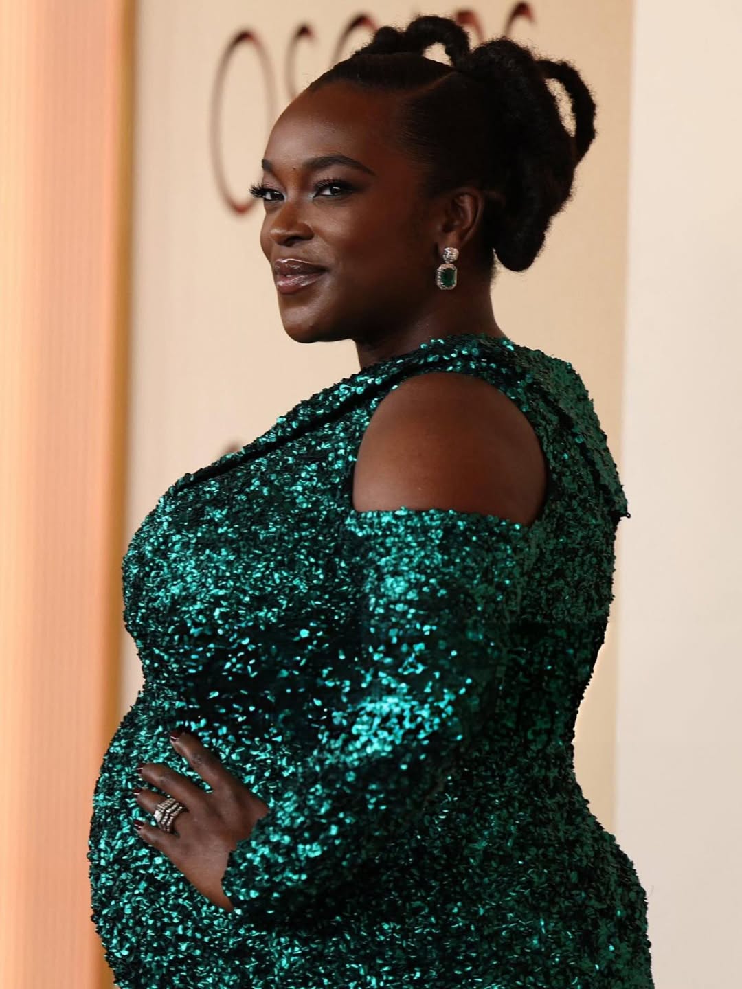 Wunmi Mosaku on the 2026 Oscars red carpet in a custom emerald green Louis Vuitton gown, celebrating her Best Supporting Actress nomination for Sinners.