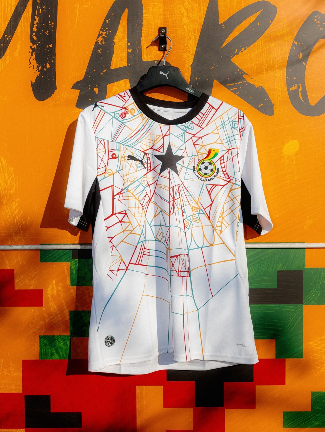 The 2026 Puma Ghana home jersey in white, featuring a multi-coloured cobweb pattern inspired by Kwaku Ananse.