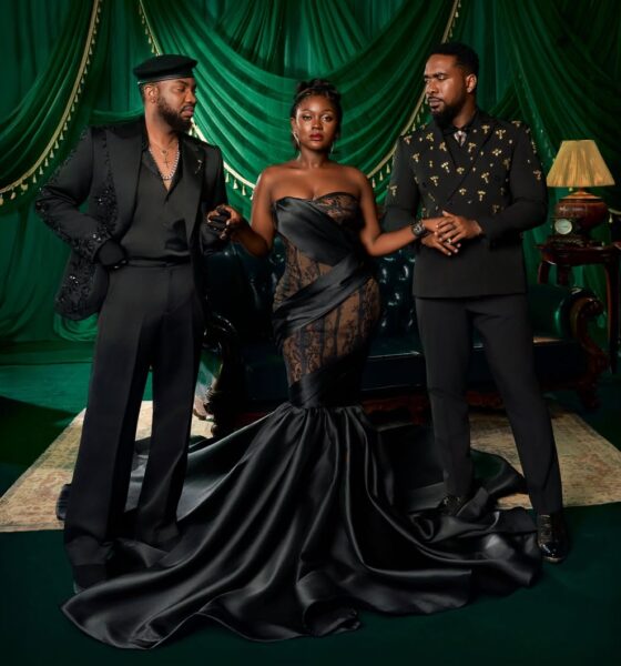 Osas Okonyon in a dramatic black strapless mermaid gown, positioned between co-stars Ibrahim Suleiman (left) and Uzor Arukwe (right) for a promotional portrait for the 2026 film Evi, directed by Uyoyou Adia.