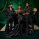 Osas Okonyon in a dramatic black strapless mermaid gown, positioned between co-stars Ibrahim Suleiman (left) and Uzor Arukwe (right) for a promotional portrait for the 2026 film Evi, directed by Uyoyou Adia.