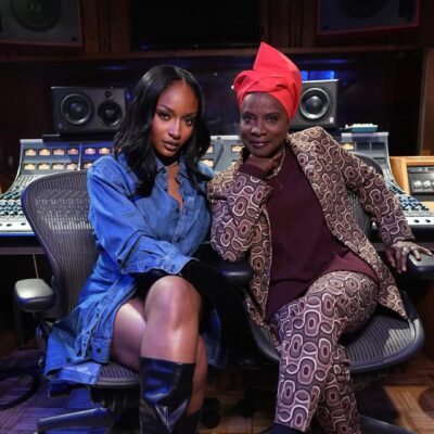Angélique Kidjo and Ayra Starr sitting in a recording studio for their Aye Kan collaboration.