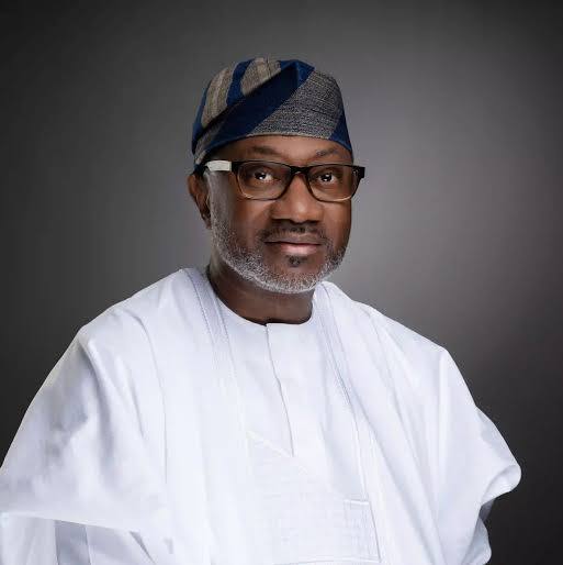 Femi Otedola, Chairman of Geregu Power, in traditional white attire and a blue patterned cap.