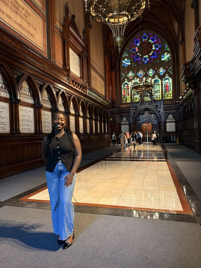 Ifeanyi Ruth Umunna smiling in a Harvard Law School cream cable-knit sweater during her J.D. orientation.