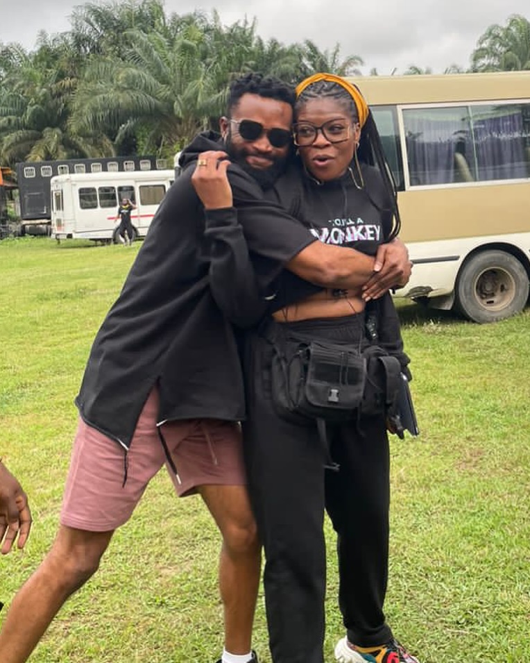 Actor Bucci Franklin and director Kemi Adetiba smiling together on the set of the series To Kill A Monkey.