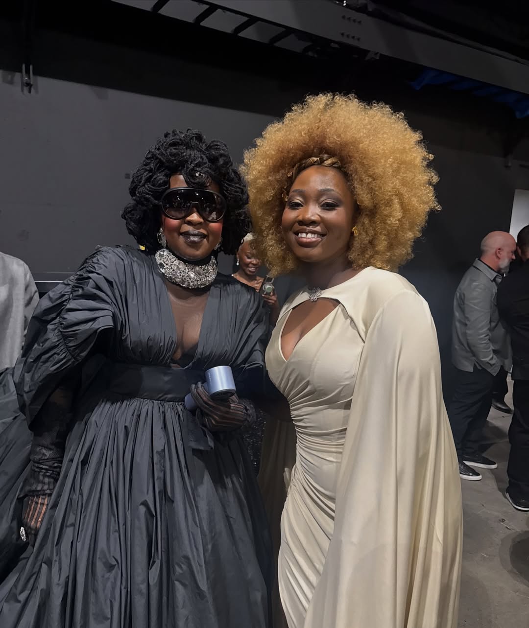 Alexia Jayy in a cream gown smiling alongside the legendary Ms. Lauryn Hill backstage at the 68th Annual Grammy Awards.