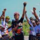 Kanyeyachukwu Tagbo-Okeke and a group of Nigerian cyclists raising their fists in a power salute for autism awareness.