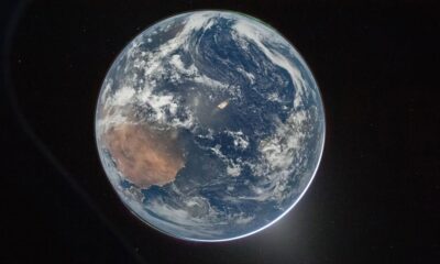 High-resolution full disk image of Earth from space showing the African continent, aurora, and city lights from the Orion capsule.