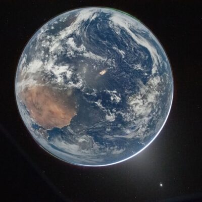 High-resolution full disk image of Earth from space showing the African continent, aurora, and city lights from the Orion capsule.