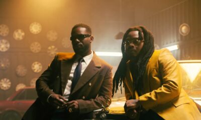 Adekunle Gold and Olamide posing in a retro garage with a vintage Mercedes-Benz for their 2026 collaboration 'Formation.'