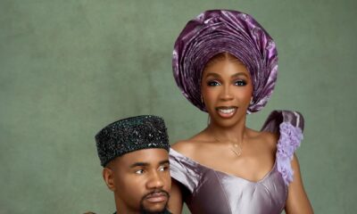 Nollywood actor Jide Kene Achufusi in a forest green Agbada and black beaded cap seated beside his bride, Ifeoma, who is wearing a lilac structured corset top and floral lace mermaid skirt for their pre-wedding photoshoot.