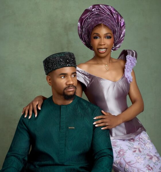 Nollywood actor Jide Kene Achufusi in a forest green Agbada and black beaded cap seated beside his bride, Ifeoma, who is wearing a lilac structured corset top and floral lace mermaid skirt for their pre-wedding photoshoot.