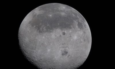 A full view of the Moon showing the dark lava flows of the near side and the cratered far side, with the Orientale Basin in the centre.