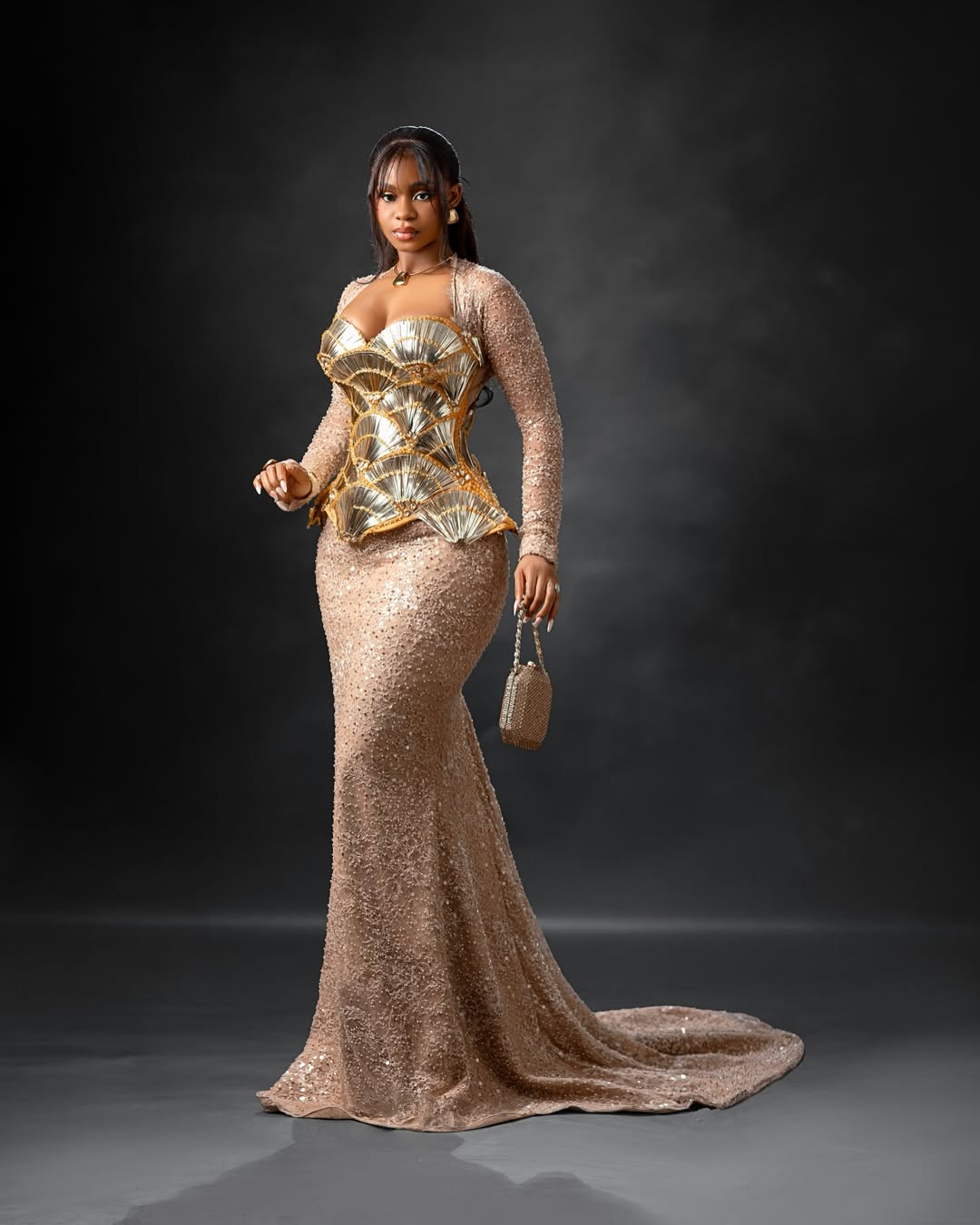 Priscilla Ojo in a tiered gold metallic seashell corset over a champagne crystal mermaid gown.